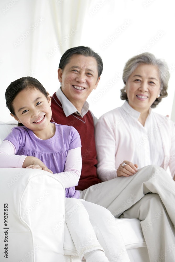 Chinese grandaughter with grandparents in living room Chinese grandaughter with grandparents in living room