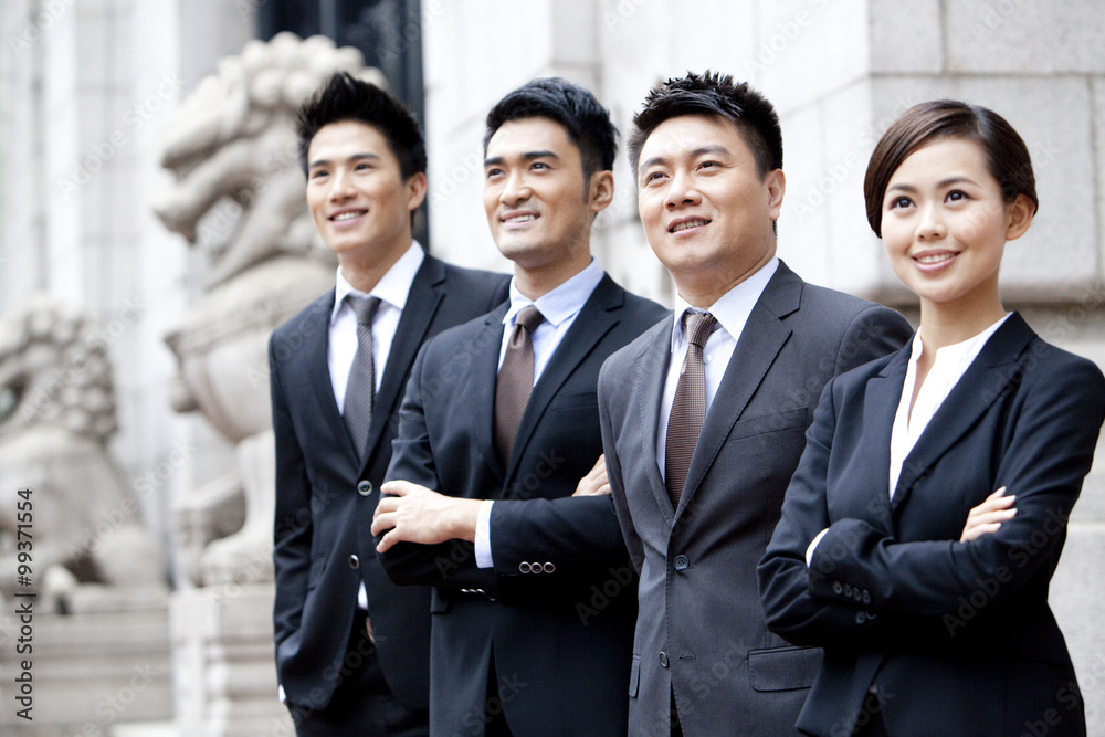 Confident business team looking at view outdoors, Hong Kong Confident business team looking at view outdoors, Hong Kong