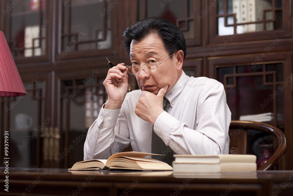 Experienced businessman with speculative look in eyes Experienced businessman with speculative look in eyes