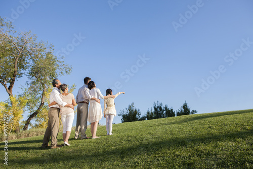 Intimate family looking at view in a park