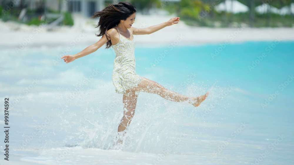 Beautiful Asian Chinese girl smiling on beach Beautiful Asian Chinese girl smiling on beach