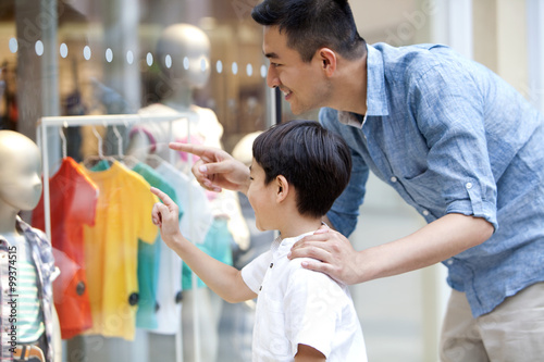 Father and son shopping in department store