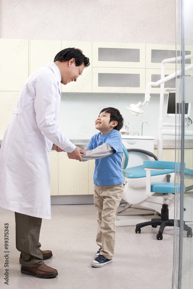 Dentist shaking hands with a little patient Dentist shaking hands with a little patient