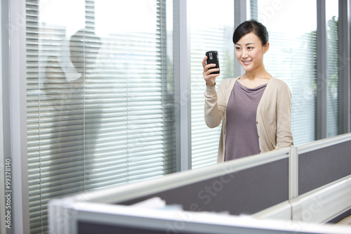 Confident Young Businesswoman Reading Text Message