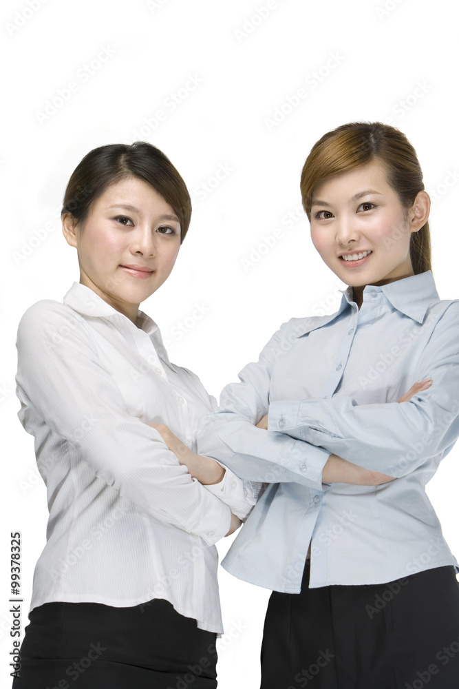Young businesswomen standing together, arms crossed Young businesswomen standing together, arms crossed