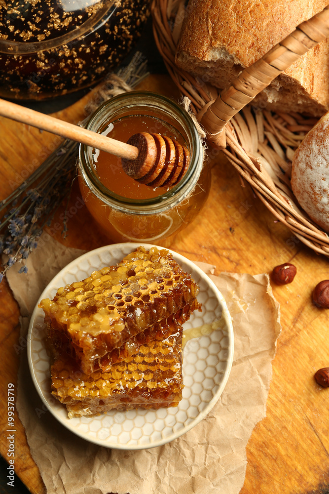 Honeycombs on plate, hot buns on wooden background Honeycombs on plate, hot buns on wooden background