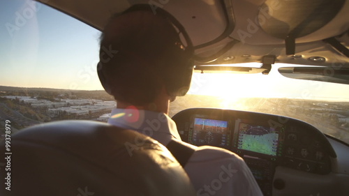Pilot Operates Private Plane At Sunset View. Close Up Shot Of Airplane Cabin.