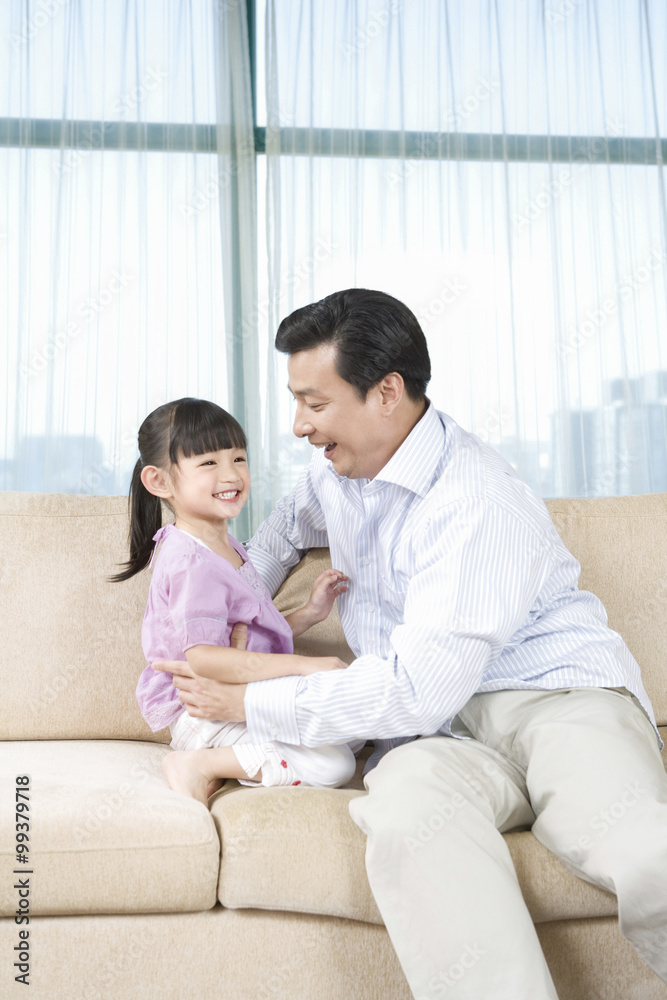 Girl and father on couch Girl and father on couch