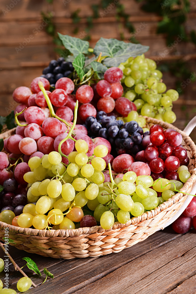 Grape in basket on wooden table Grape in basket on wooden table
