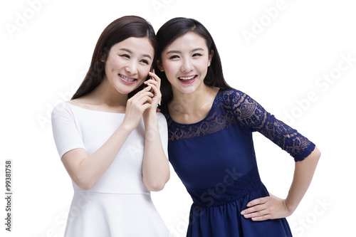 Female friends listening to phone together