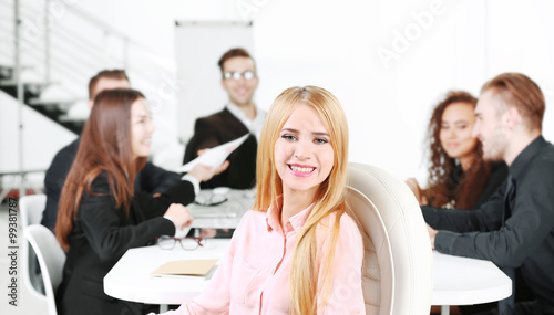 Photo of business woman with her staff in conference room at the meeting