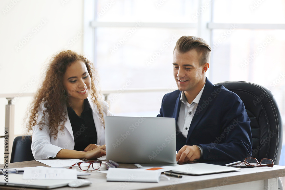 Businessman and businesswoman working in office Businessman and businesswoman working in office