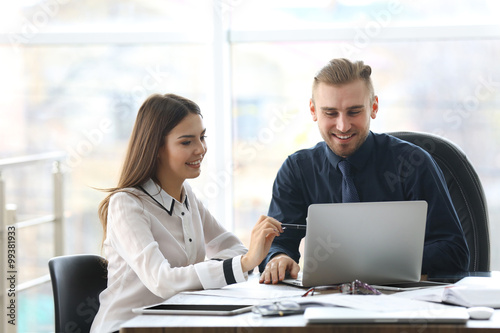 Businessman and businesswoman working in office