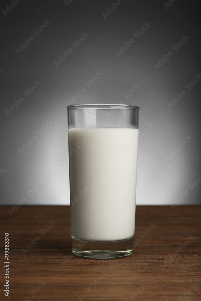 Glass of milk on table on dark background Glass of milk on table on dark background