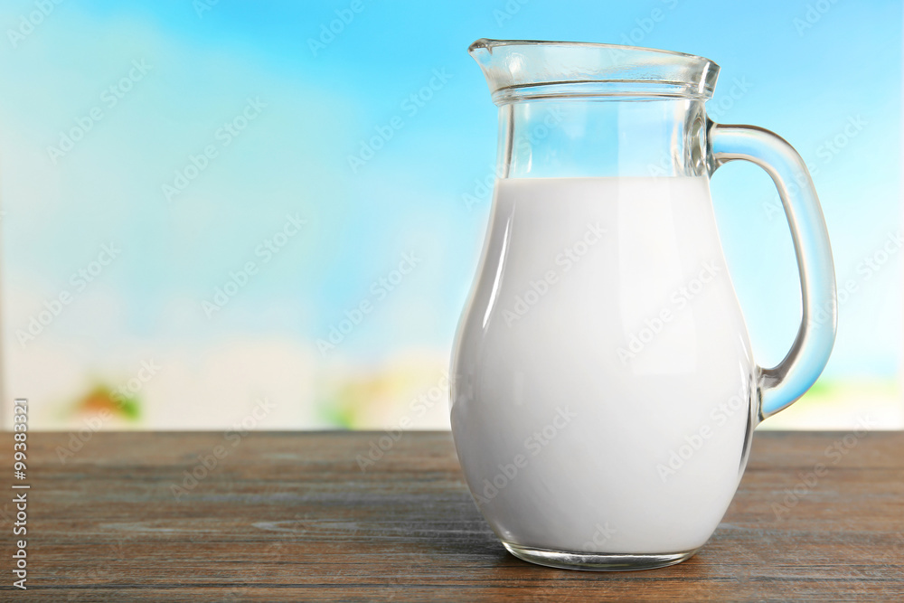 Jar of milk on blurred natural background