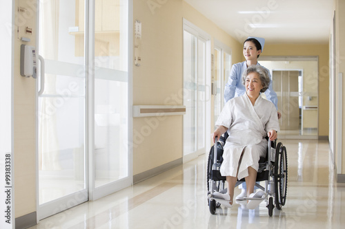 Nurse taking care of senior woman in wheel chair