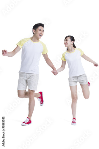 Happy young couple holding hands