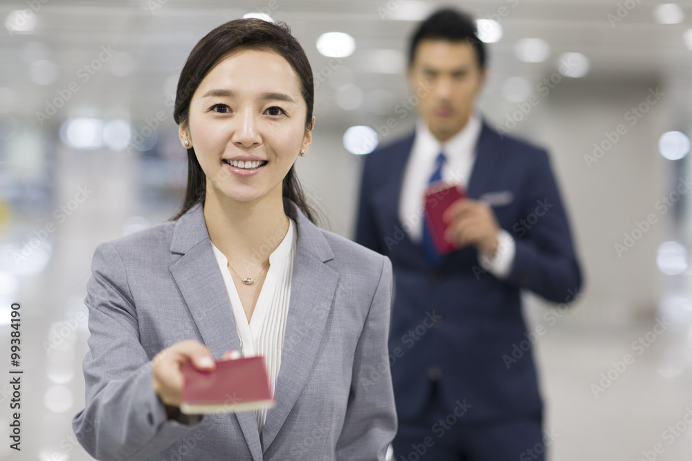 Young businesswoman showing her passport in airport Young businesswoman showing her passport in airport