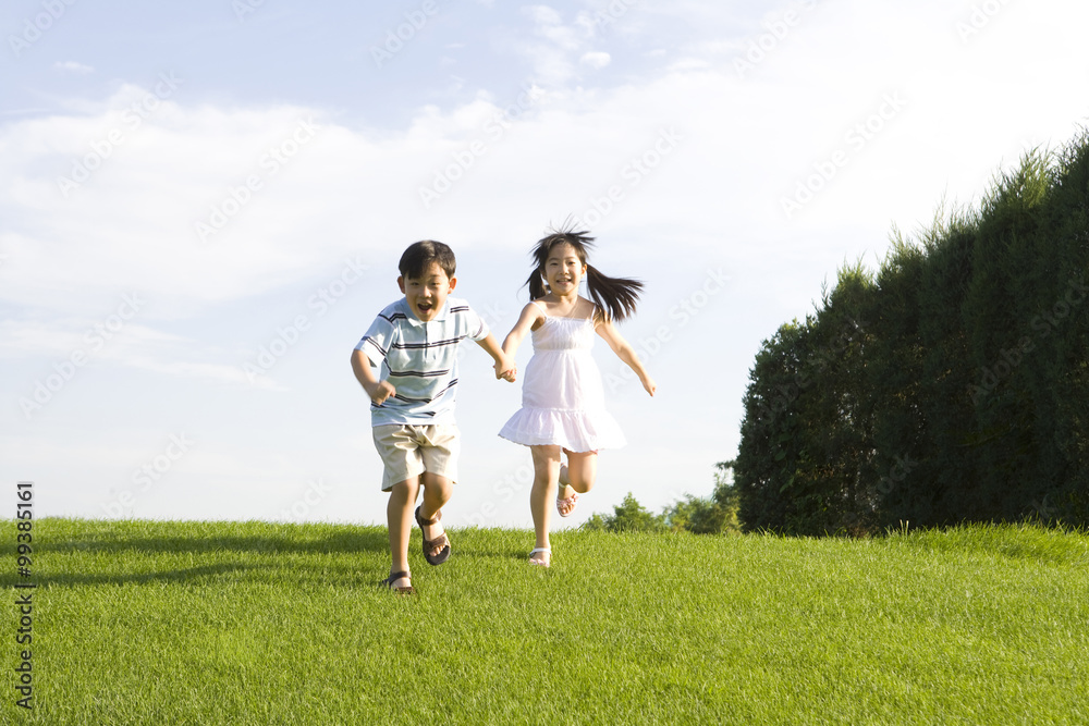 Children holding hands and running outdoors Children holding hands and running outdoors