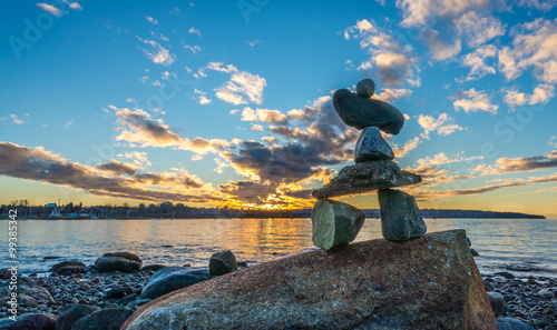 inukshuk in the sunset on the beach photo