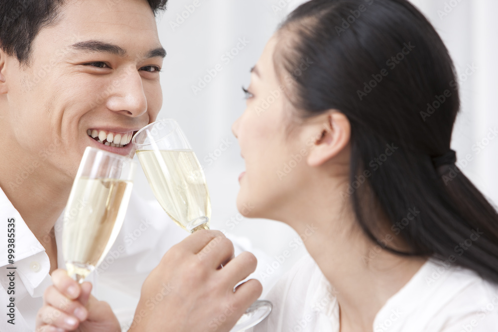 Happy young couple drinking champagne Happy young couple drinking champagne