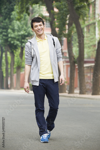 Male college student walking on campus © Blue Jean Images