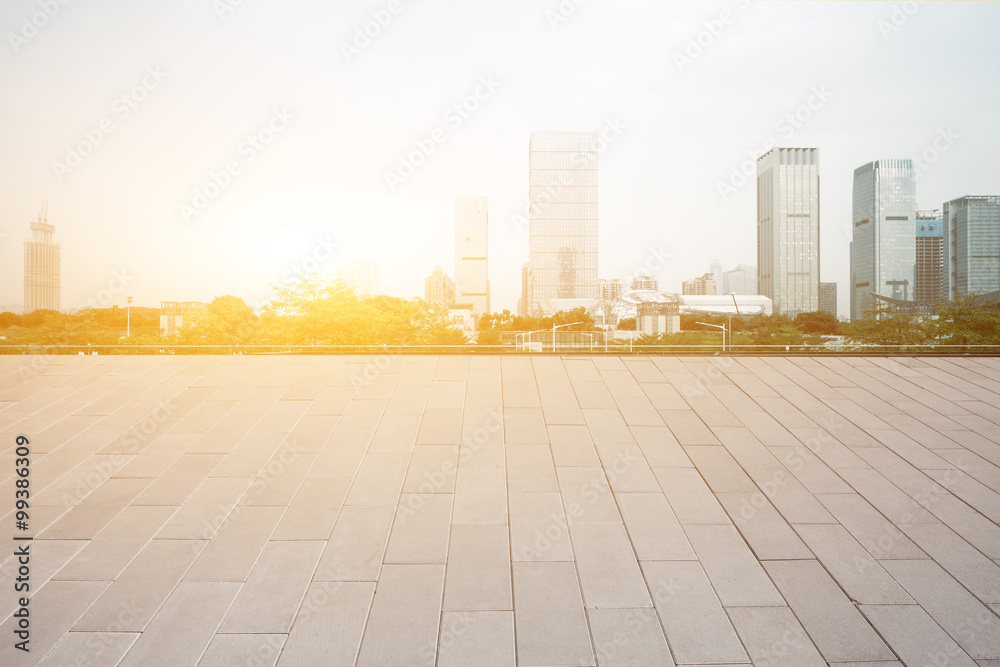 empty floor with backdrop on modern cityscape at sunrise time