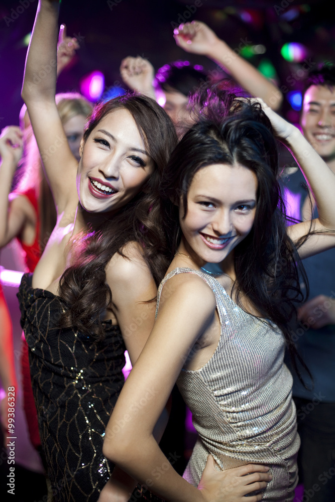 Stylish young people dancing in nightclub