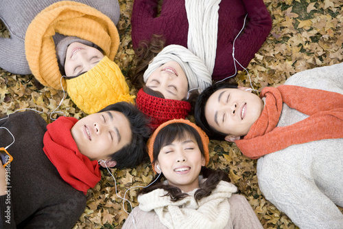 Friends Lying Amongst Maple Leaves Shaing MP3 Players photo