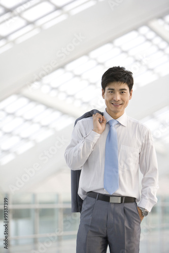 Businessman jacket over shoulder