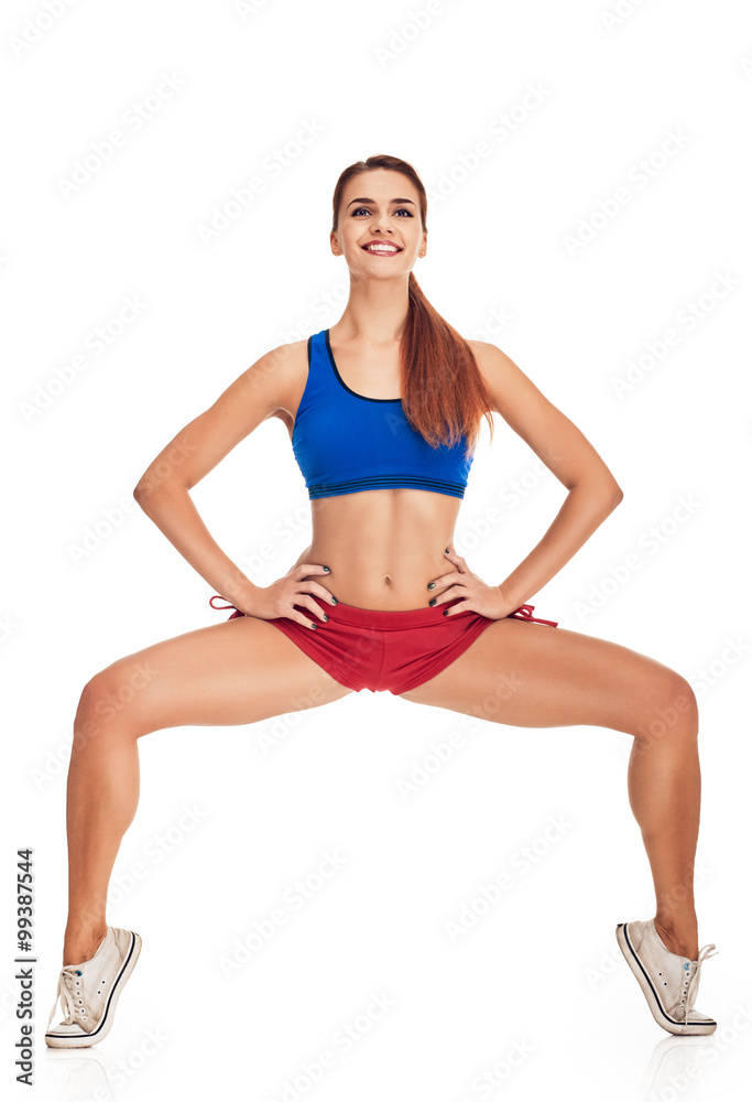 young woman with slim body. squatting on tiptoes young woman with slim body. squatting on tiptoes