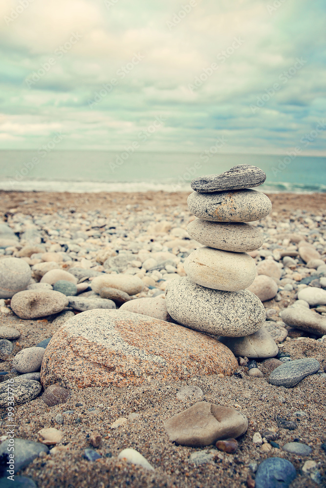 Stacked stones on the beach. Summer, vacation, travel, spa, relaxation, nautical and life style concept Stacked stones on the beach. Summer, vacation, travel, spa, relaxation, nautical and life style concept