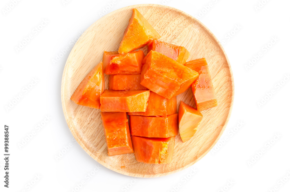 Piece of ripe papaya fruit on wooden plate Piece of ripe papaya fruit on wooden plate