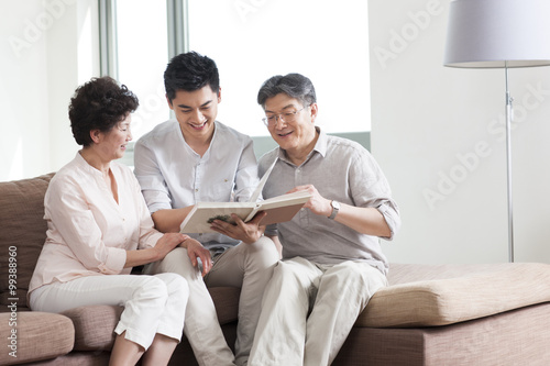 Happy family looking at photo album