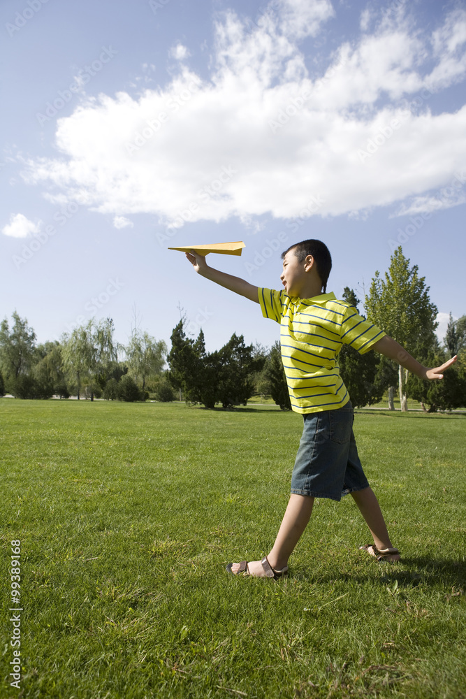 Boy playing with a paper airplane Boy playing with a paper airplane