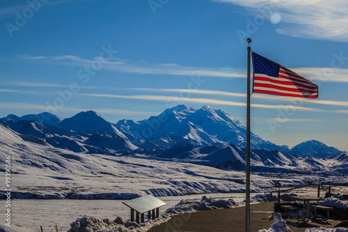 USA flag at Eielson Visitor Center in Mount Denali ( McKinley) background, Denali National Park, Alaska, USA Denali is the highest mountain peak in North America.