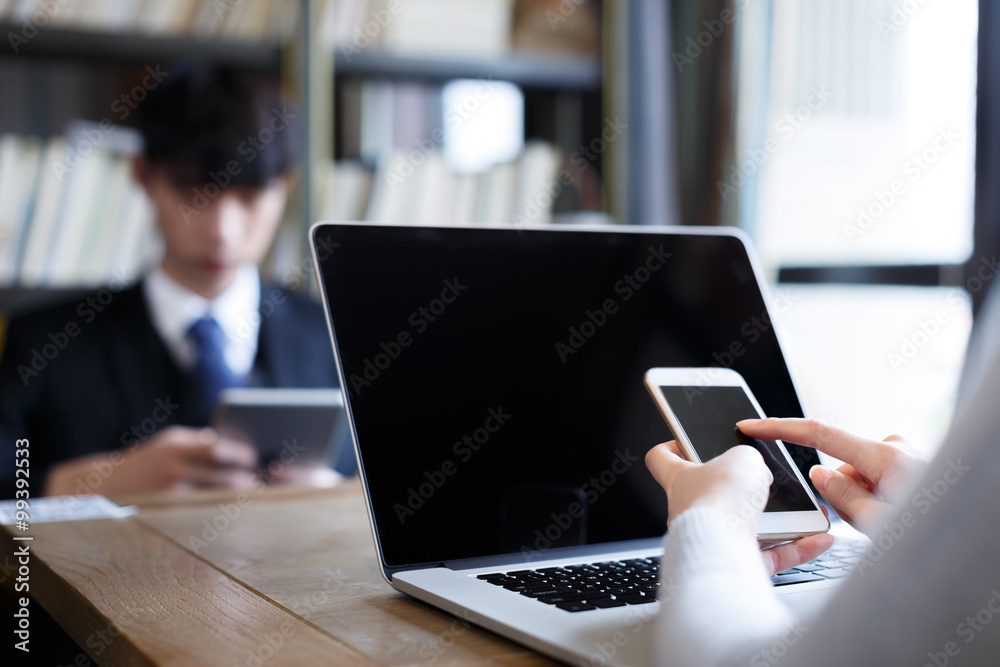 people using laptop tablet smart phone in room people using laptop tablet smart phone in room