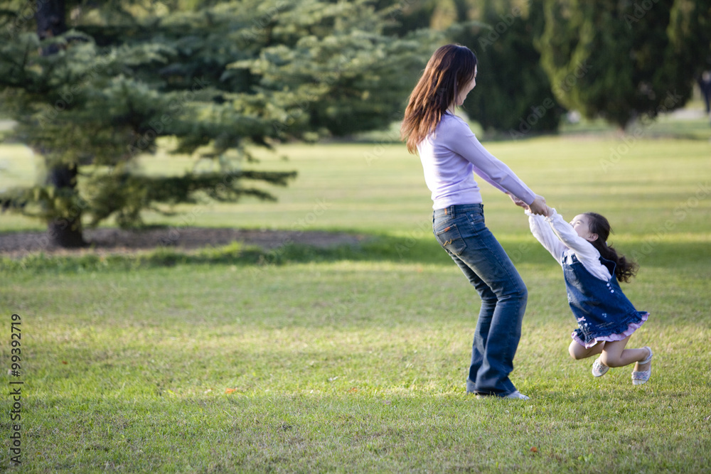 Mother and daughter playing in the park Mother and daughter playing in the park