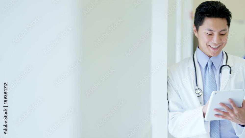Portrait of Chinese American male doctor working on technology in medical center Portrait of Chinese American male doctor working on technology in medical center