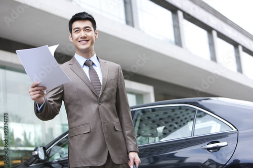 Young businessman reading file