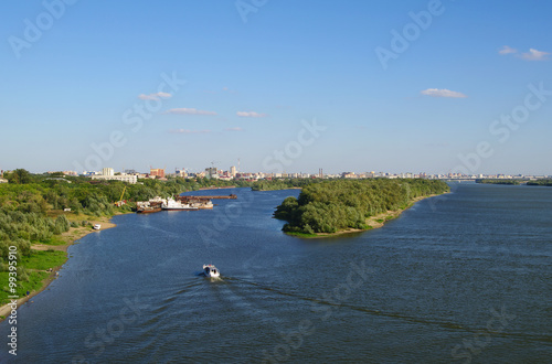 Top view Irtysh river with sandy bar, pier and ships,  panorama of city on back plane, Omsk, Russia   