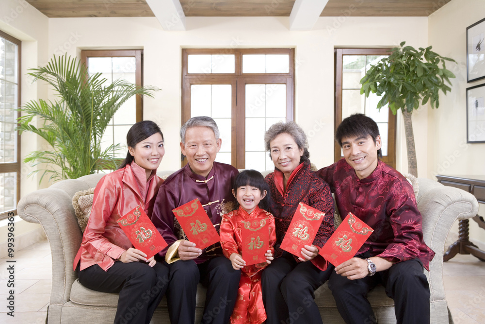 Fototapeta premium Three generation family holding Chinese new year red envelope