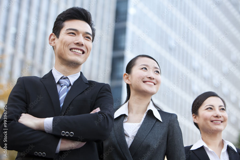 A team of businesspeople outside office buildings A team of businesspeople outside office buildings