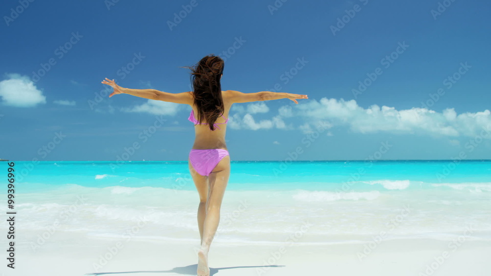 Young Asian Chinese female wearing bikini enjoying tropical beach vacation Young Asian Chinese female wearing bikini enjoying tropical beach vacation