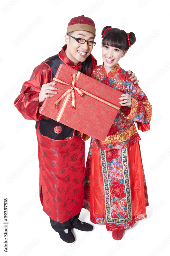 Sweet couple in traditional Chinese clothing holding gift boxes Sweet couple in traditional Chinese clothing holding gift boxes