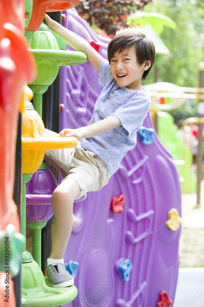 Little boy playing in amusement park Little boy playing in amusement park