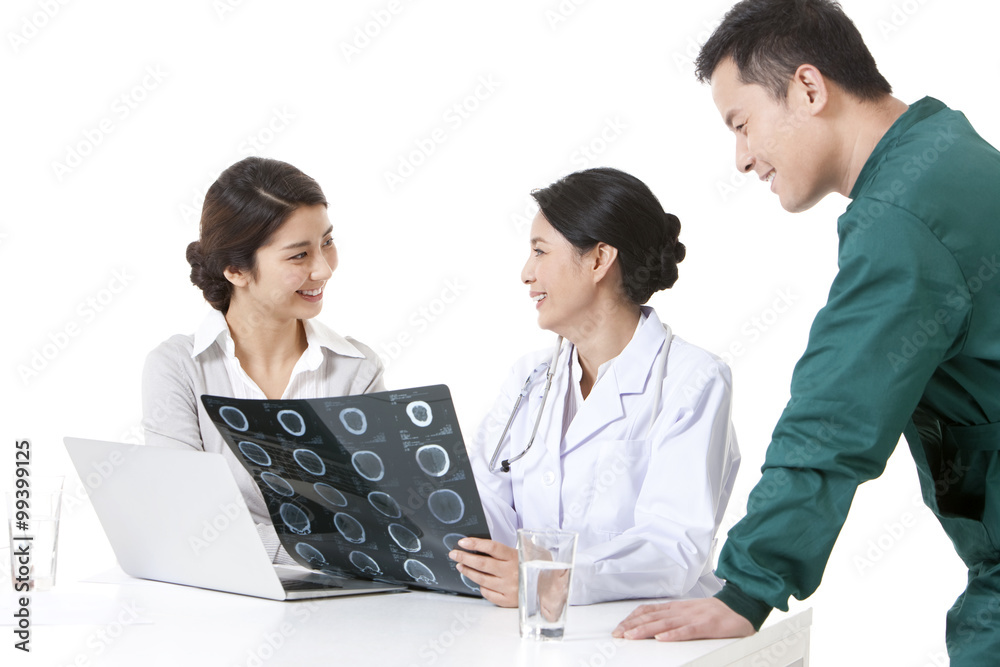 Professional doctors checking X-ray image with young woman Professional doctors checking X-ray image with young woman