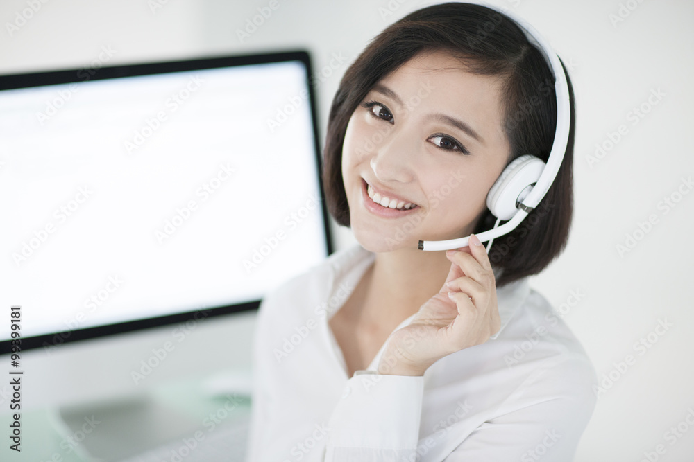 Cheerful businesswoman with headset in office Cheerful businesswoman with headset in office