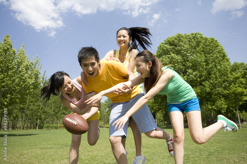 Group of friends playing American Football Group of friends playing American Football