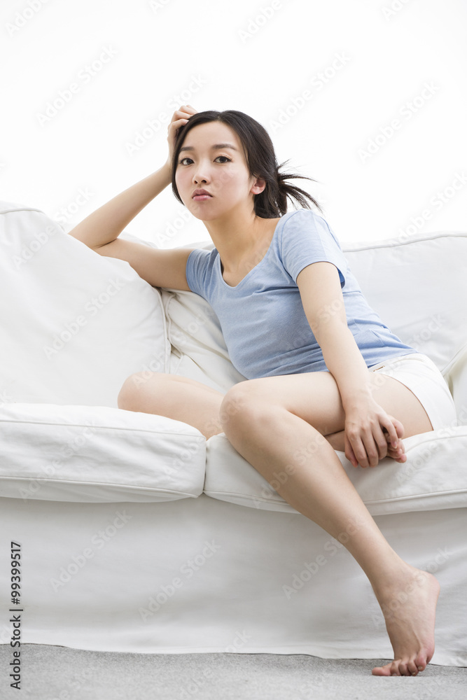 Young woman sitting on sofa Young woman sitting on sofa